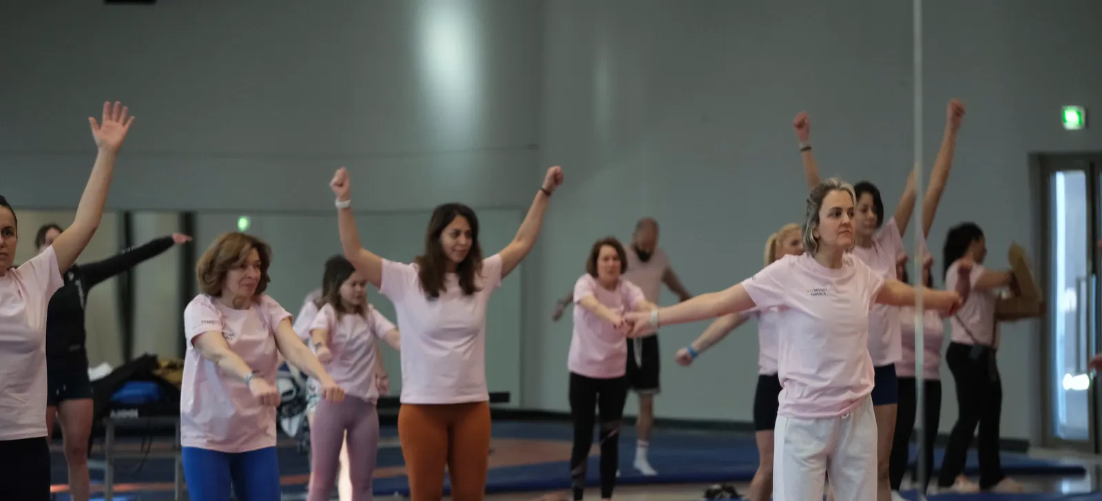February 2025, Gloria Sports Arena: a group raising their arms during dryland training.