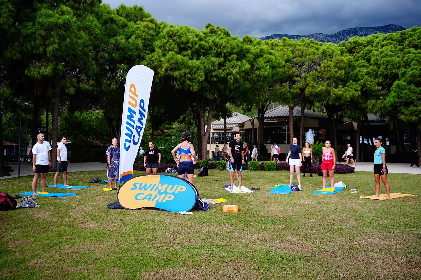 October 2026, Kemer: a group yoga and breathing session on the lawn near the beach.