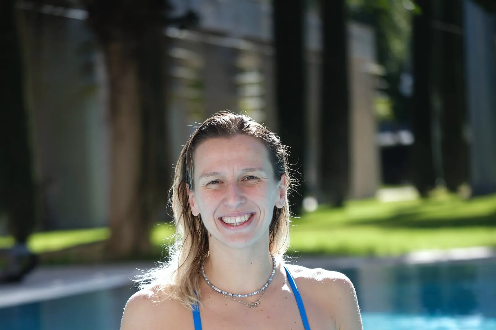 Nida Eliz Üstündağ smiles at the poolside at Gloria Sports Arena between training sessions.